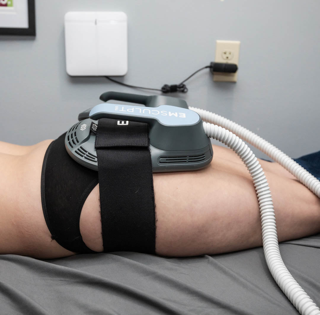 Female patient receiving an Emsculpt NEO treatment on her buttocks at Chinn GYN