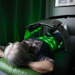 Emerald Laser patient relaxing in a dim lit room during her session.