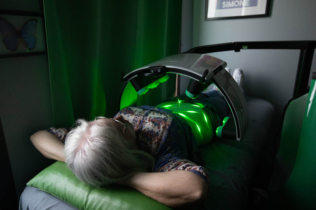 Emerald Laser patient relaxing in a dim lit room during her session.