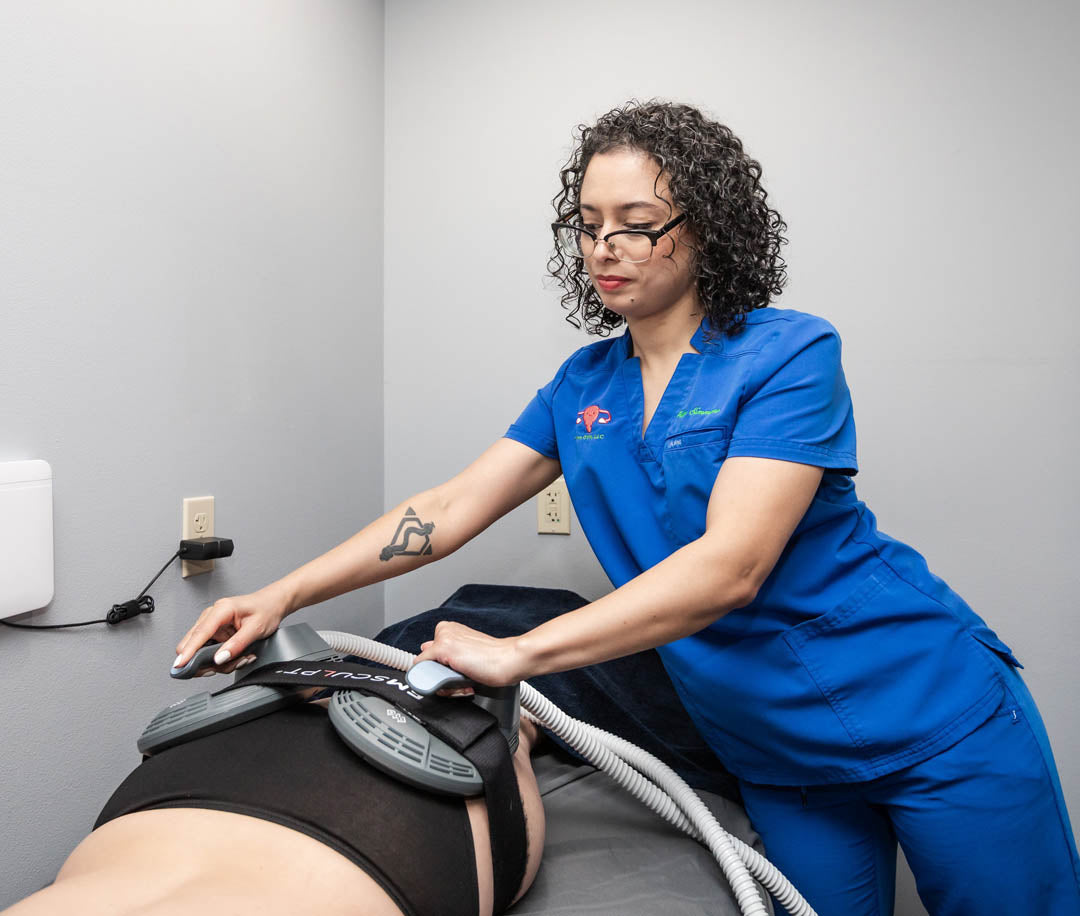 RN at Chinn GYN placing Emsculpt NEO machine on patients buttocks